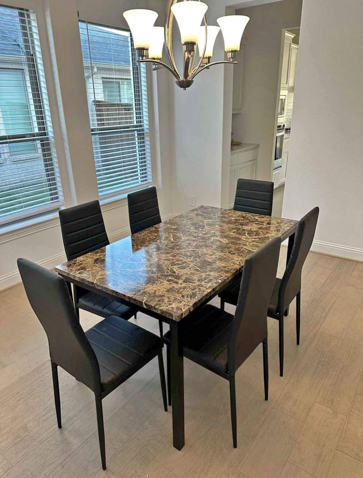 Marble-look dining table with 6 black upholstered chairs