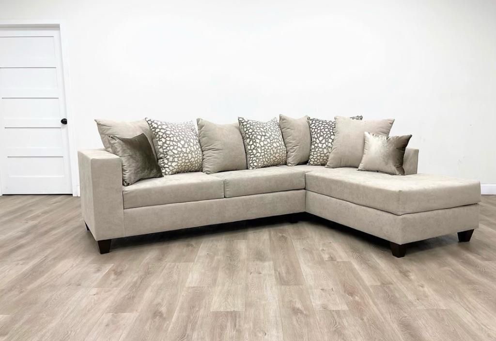 Beige sectional with dot pattern pillows